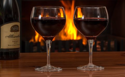 red wine, glasses, log fire