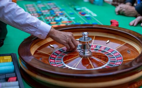 a man is playing a game of roule on a green table